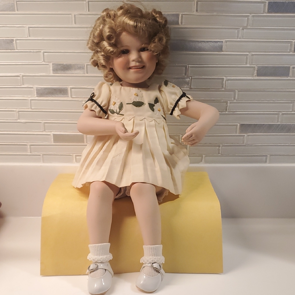 Danbury Mint Shirley Temple Doll In Yellow Floral Dress. Sitting position.